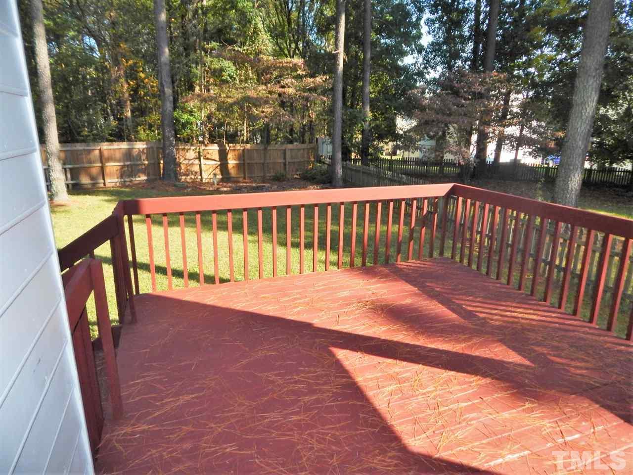 4829 Draper Road Raleigh, NC 27616 - Photo 4 of 25 a view of a porch with wooden floor and fence
