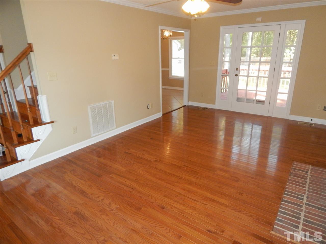 4829 Draper Road Raleigh, NC 27616 - Photo 7 of 25 a view of an empty room with wooden floor and a window