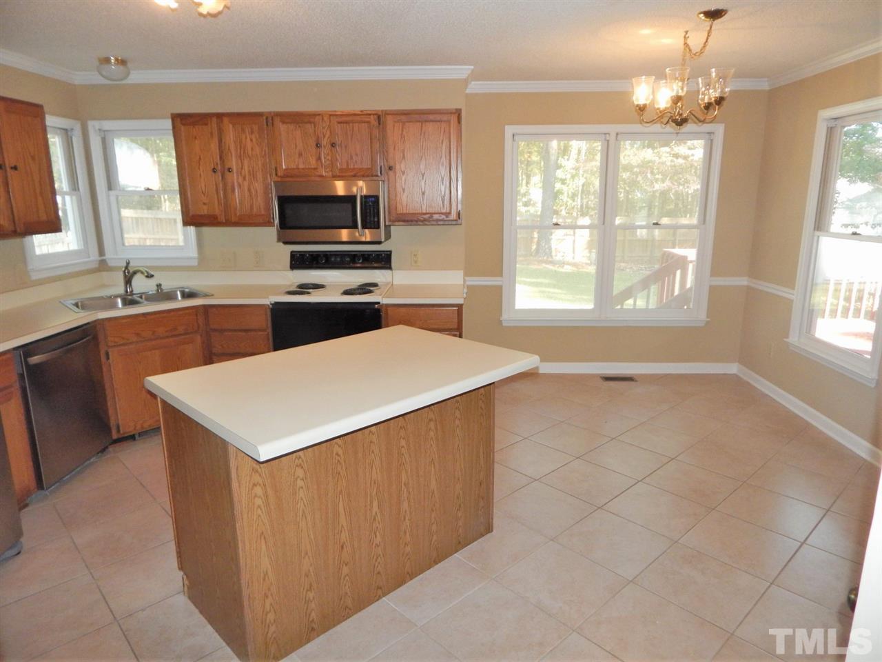 4829 Draper Road Raleigh, NC 27616 - Photo 8 of 25 a kitchen with a stove a sink and a microwave