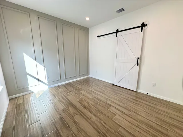 a view of walk in closet with wooden floor