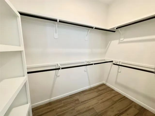a view of a room with wooden floor and entryway