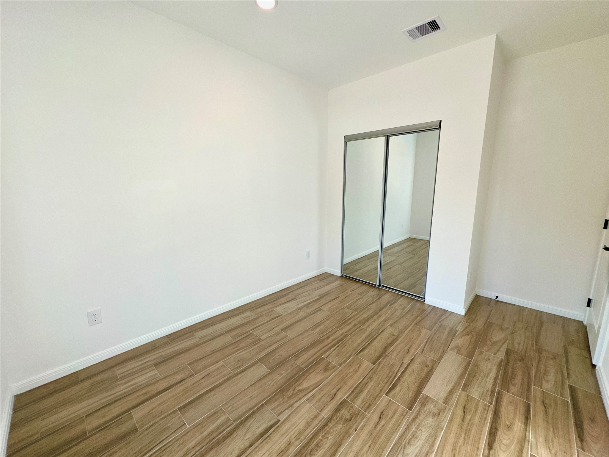 11563 Persimmon Street Willis, TX 77318 - Photo 15 of 19 a view of wooden floor in a room