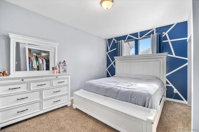 a bedroom with a bed and a dresser