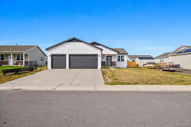a white house with a large tree in front of it