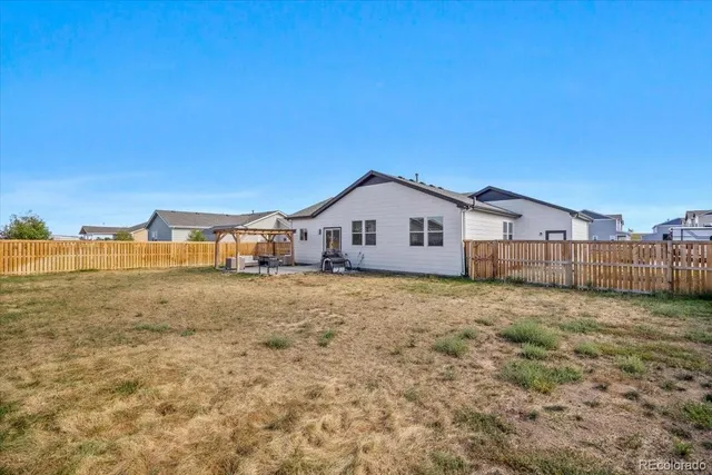 a view of a house with backyard and deck