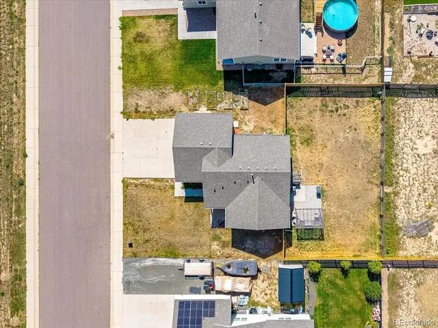 an aerial view of residential houses with outdoor space