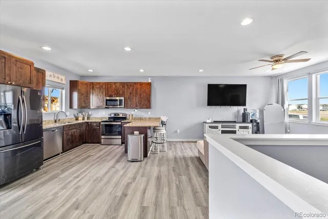 a kitchen with a sink stainless steel appliances and counter space