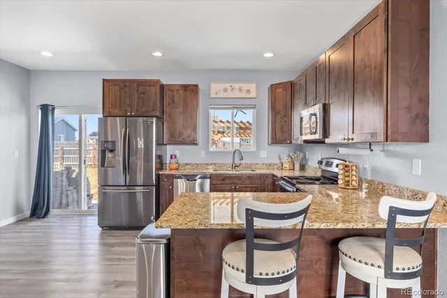 a kitchen with a refrigerator and a stove top oven