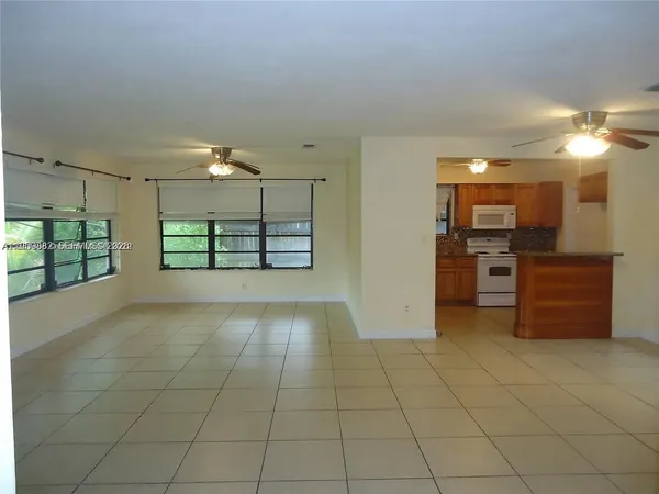 a view of a kitchen with furniture and an empty room
