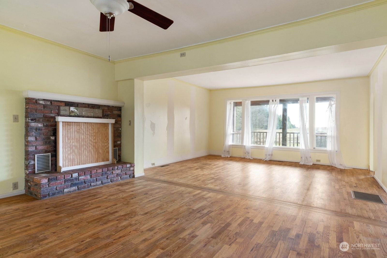 2575 Thompson Road Langley, WA 98260 - Photo 11 of 37 a view of an empty room with a window and wooden floor