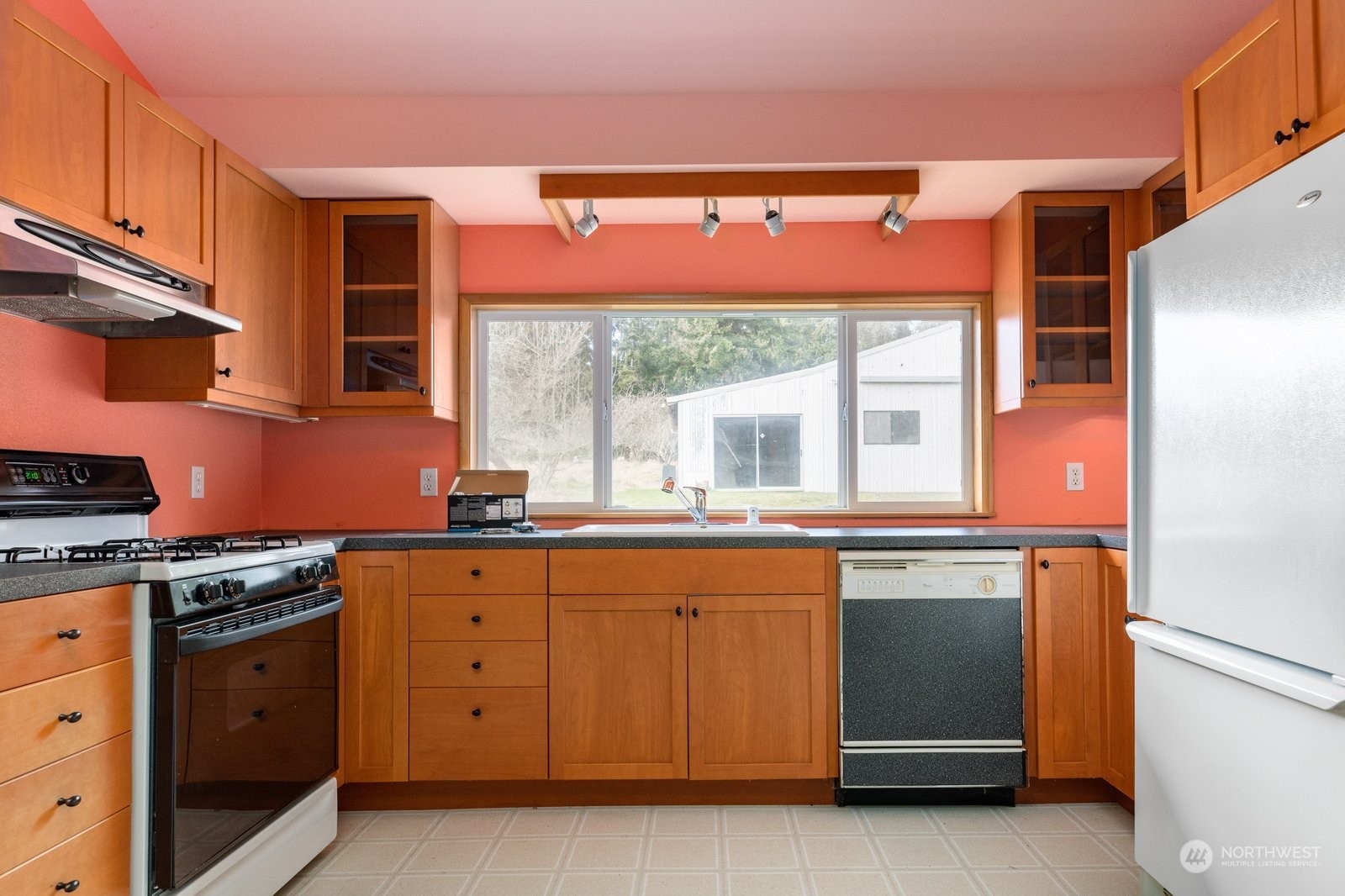 2575 Thompson Road Langley, WA 98260 - Photo 6 of 37 a kitchen with granite countertop a stove a sink and a microwave