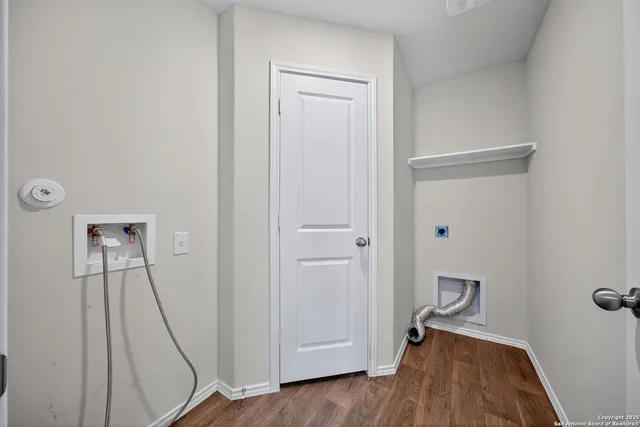 a view of a room with wooden floor and entryway