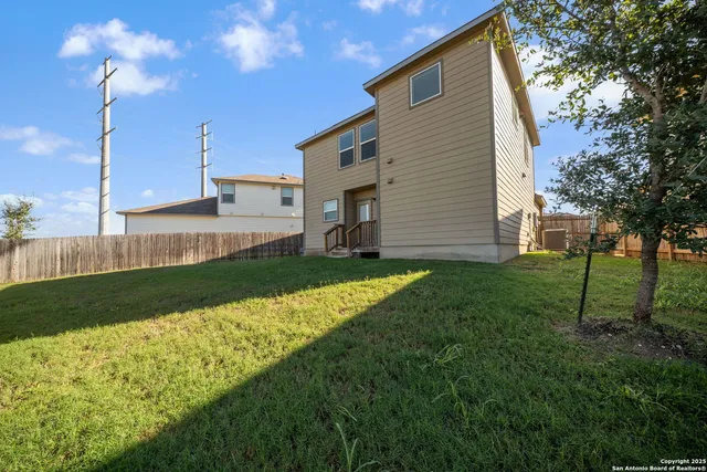 a view of a house with a backyard