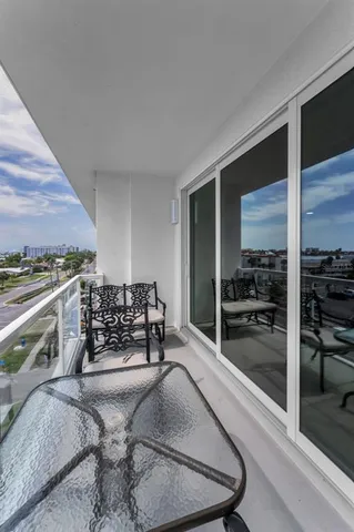 a kitchen with kitchen island granite countertop a sink a counter space stainless steel appliances and cabinets