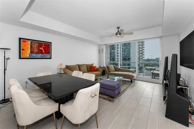 a bedroom with a bed and a flat tv screen on the dresser