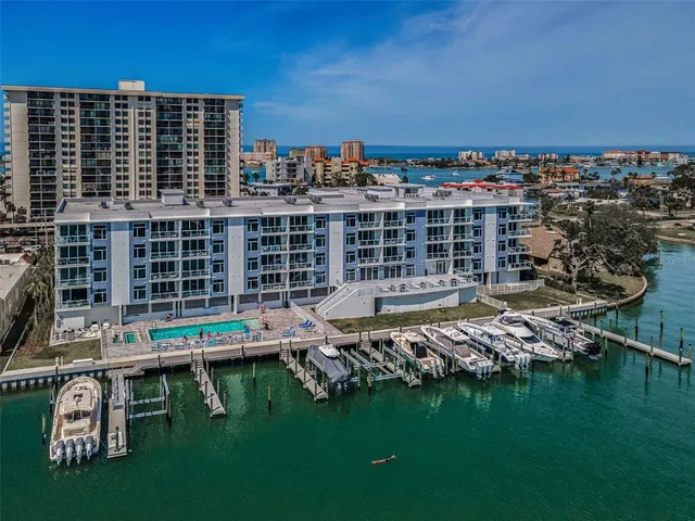 an aerial view of a residential building with outdoor space and ocean view