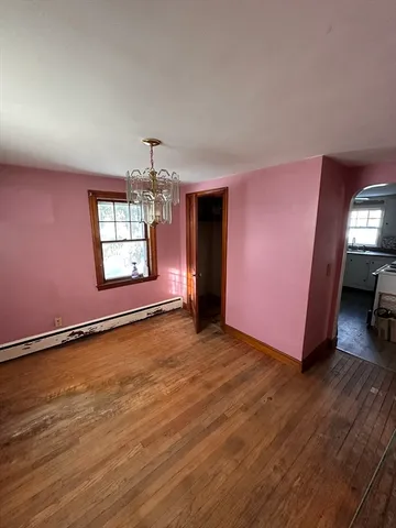 a living room with a couch and wooden floor