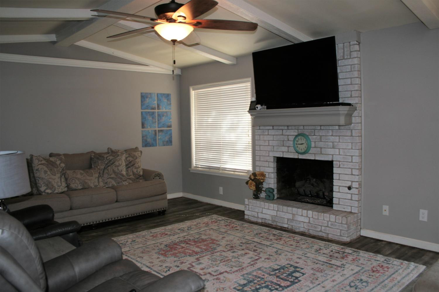 3005 92nd Street Lubbock, TX 79423 - Photo 27 of 39 Gas fireplace with logs.
