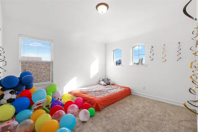 a bedroom with two beds and painting on the wall