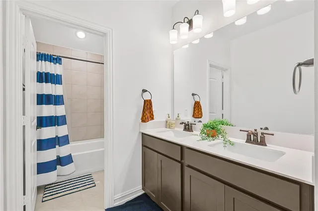 a bathroom with a sink double vanity and shower