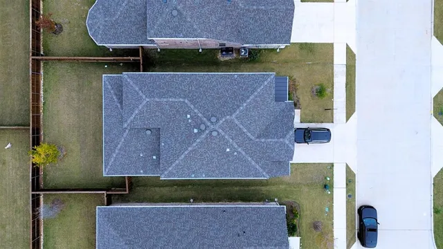an aerial view of a house with a yard