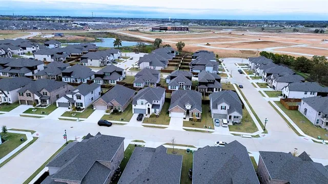 an aerial view of residential houses with outdoor space