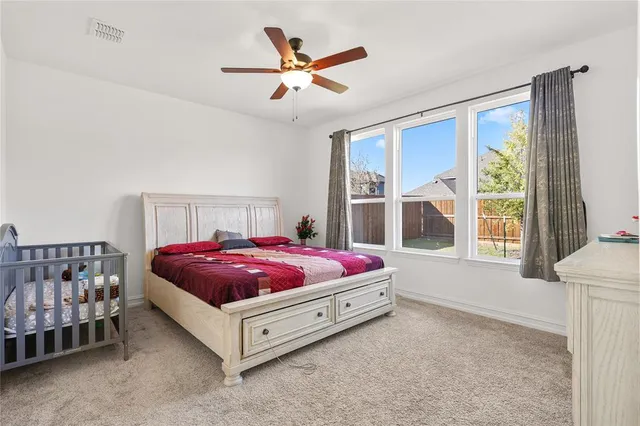 a spacious bedroom with a bed and a window