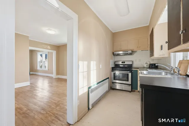 a kitchen with stainless steel appliances granite countertop a refrigerator and a stove