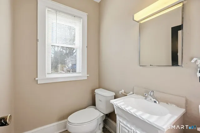 a bathroom with a sink a toilet and mirror