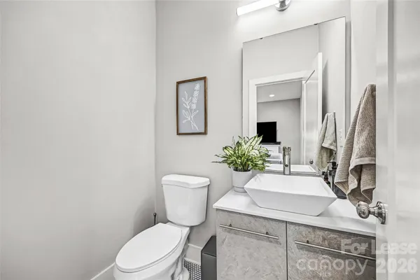 a bathroom with a sink toilet and mirror