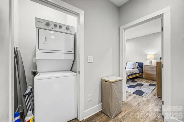 a living room with a washer and dryer