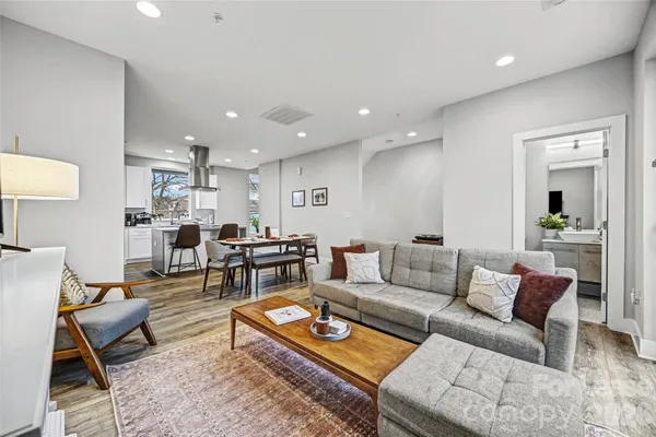 a living room with furniture kitchen view and a table