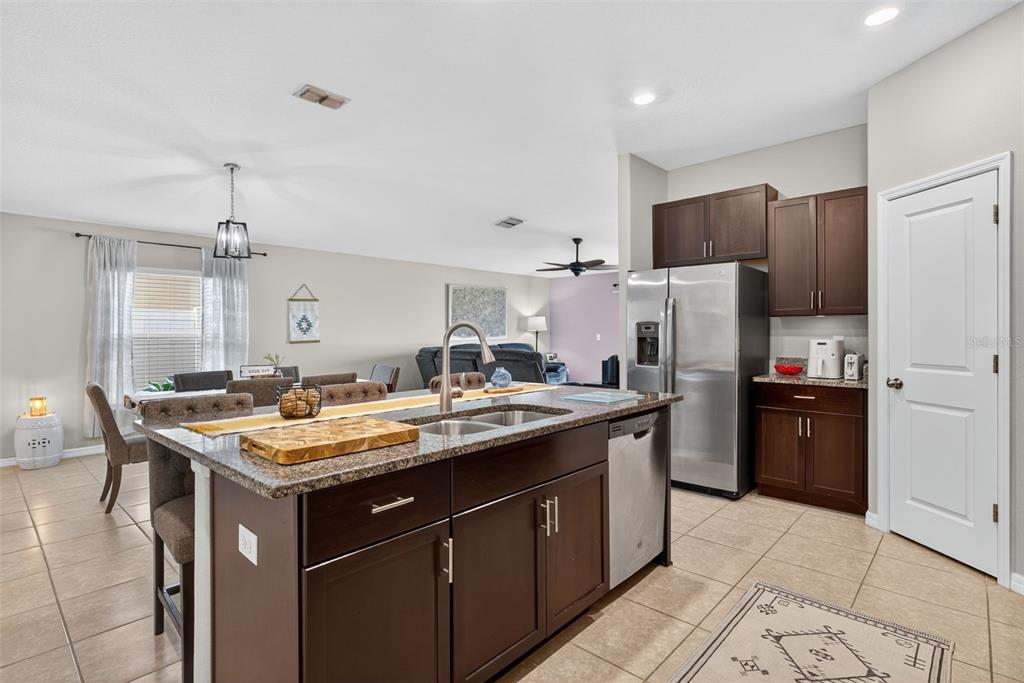 9645 Lemon Drop Loop Ruskin, FL 33573 - Photo 12 of 49 a kitchen with a stove a refrigerator and a refrigerator