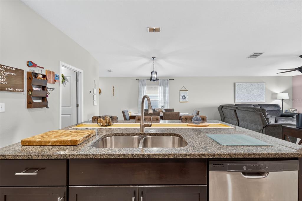 9645 Lemon Drop Loop Ruskin, FL 33573 - Photo 13 of 49 a kitchen with granite countertop a sink and cabinets