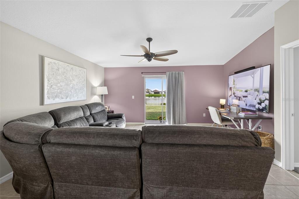 9645 Lemon Drop Loop Ruskin, FL 33573 - Photo 15 of 49 a living room with furniture a window and a chandelier