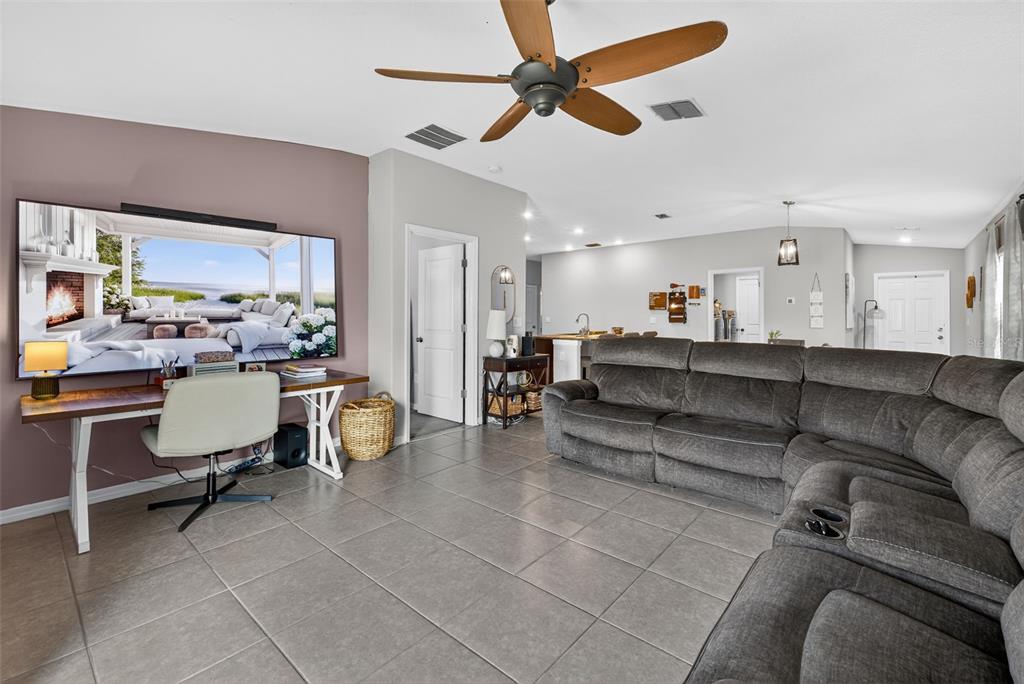 9645 Lemon Drop Loop Ruskin, FL 33573 - Photo 17 of 49 a living room with couches and kitchen view with wooden floor
