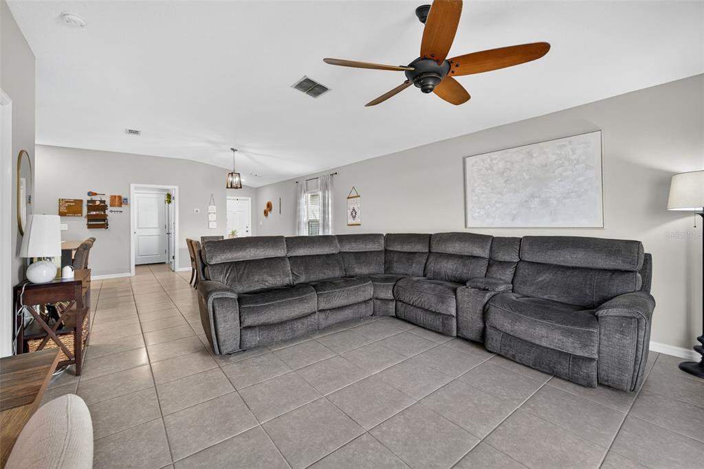 9645 Lemon Drop Loop Ruskin, FL 33573 - Photo 19 of 49 a living room with furniture and a ceiling fan