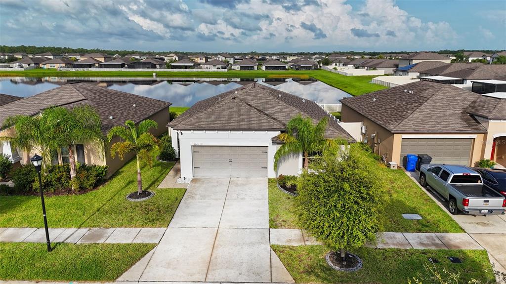 9645 Lemon Drop Loop Ruskin, FL 33573 - Photo 2 of 49 a aerial view of a house with a yard