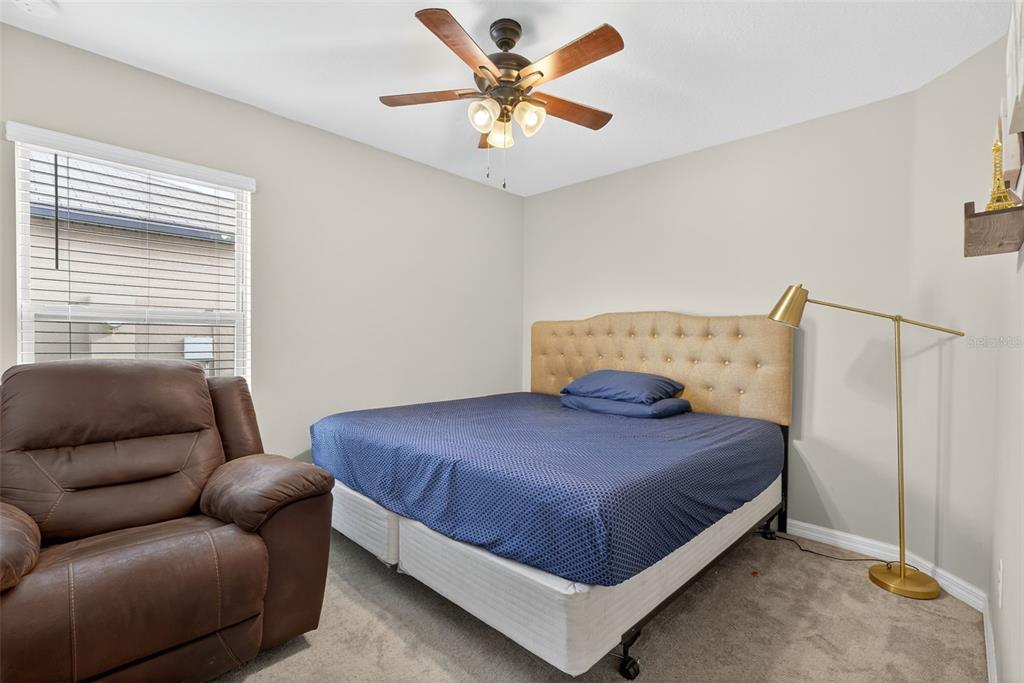 9645 Lemon Drop Loop Ruskin, FL 33573 - Photo 22 of 49 a bedroom with a bed and window