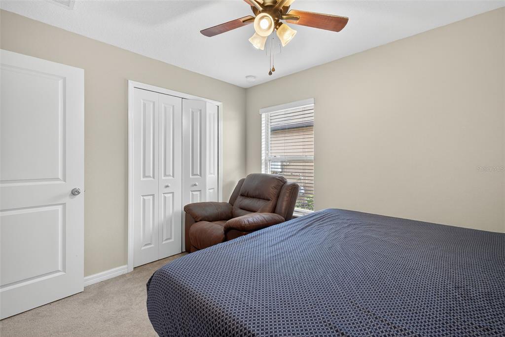 9645 Lemon Drop Loop Ruskin, FL 33573 - Photo 23 of 49 a bedroom with bed and window