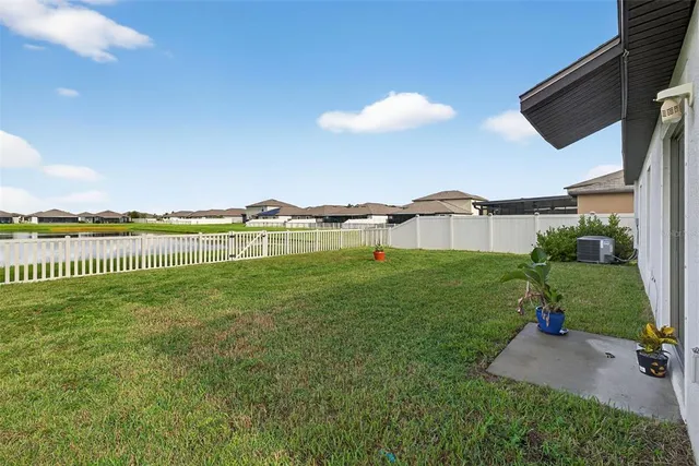 a view of a green yard next to a larger building