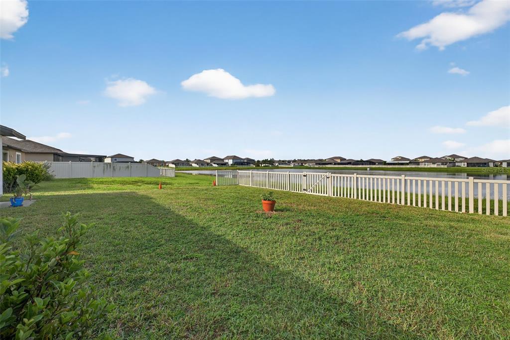 9645 Lemon Drop Loop Ruskin, FL 33573 - Photo 38 of 49 a view of a lake with a big yard