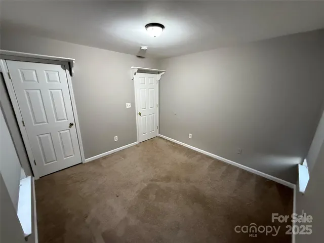 a room with gym equipment and windows