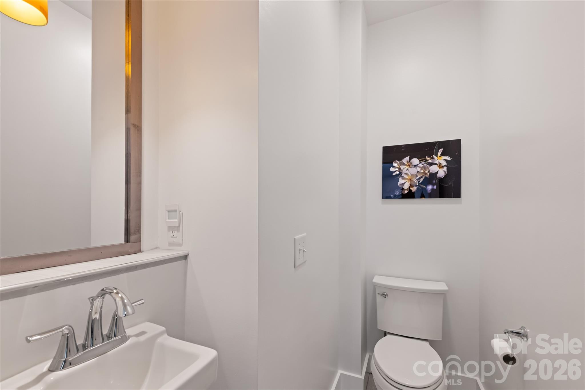 1185 Wallalieu Road Otto, NC 28763 - Photo 20 of 43 a bathroom with a toilet sink vanity and mirror