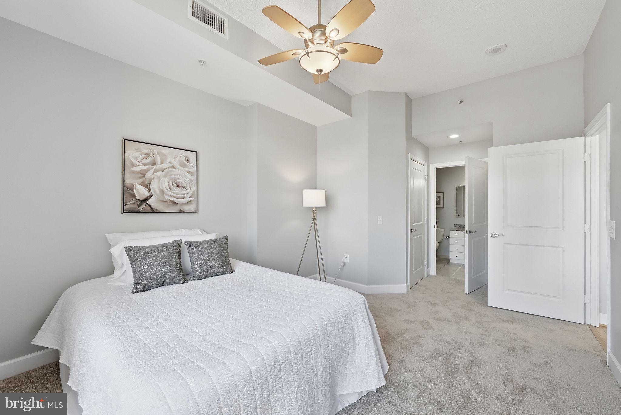 3650 South Glebe Road, Unit 1145 Arlington, VA 22202 - Photo 10 of 42 a bedroom with a bed and a chandelier