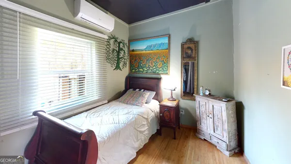 a bedroom with a bed and a window
