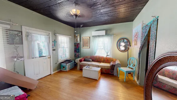a living room with furniture and a chandelier