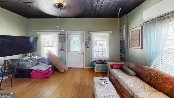 a living room with furniture window and a wooden floor