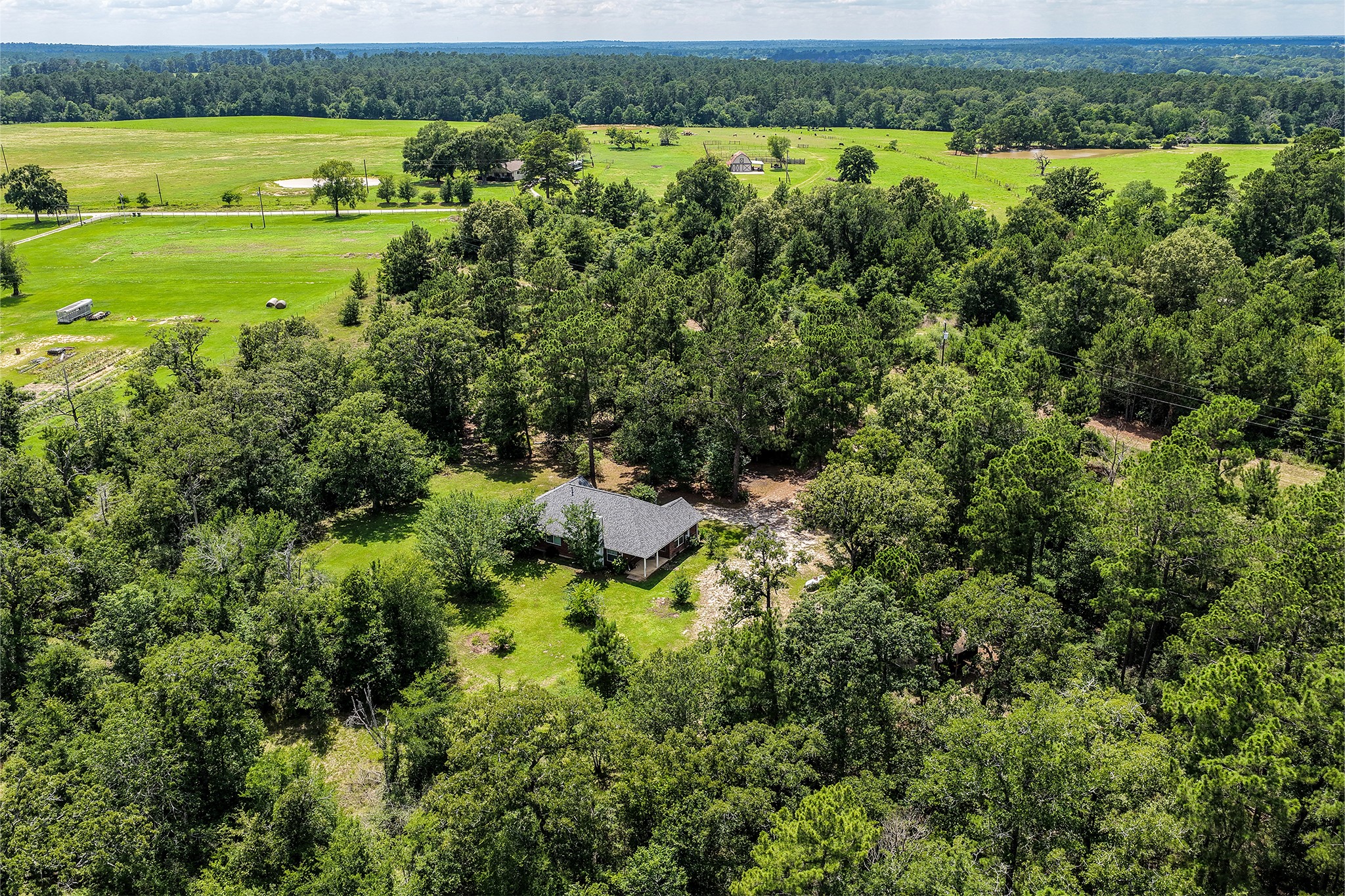 691 Bishop Road Huntsville, TX 77320 - Photo 30 of 32 an aerial view of a houses with outdoor space and trees