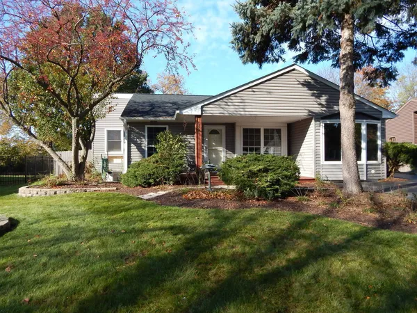 a front view of house with yard and green space
